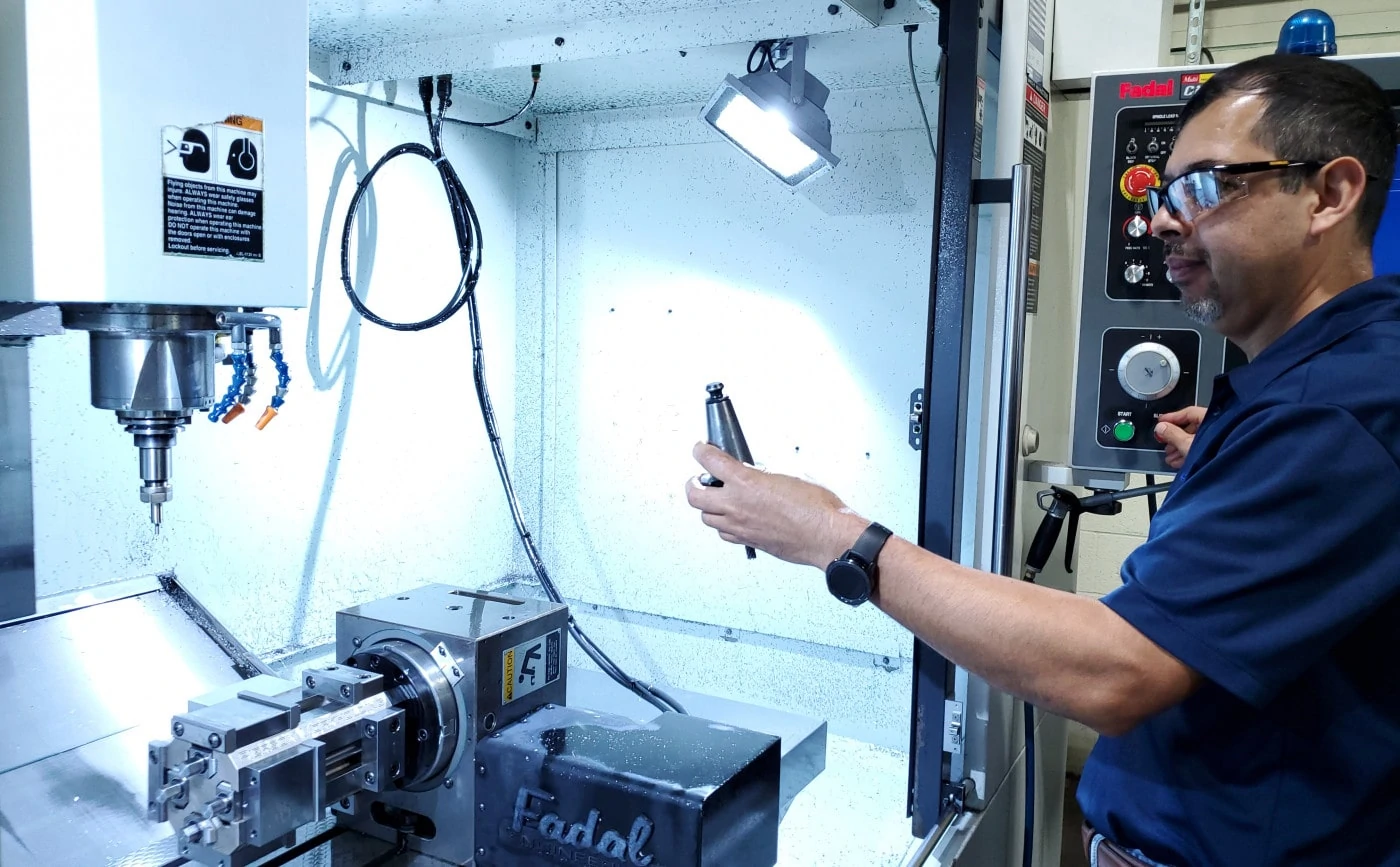 Geospace technologies employee inspecting titanium end mills in a facility