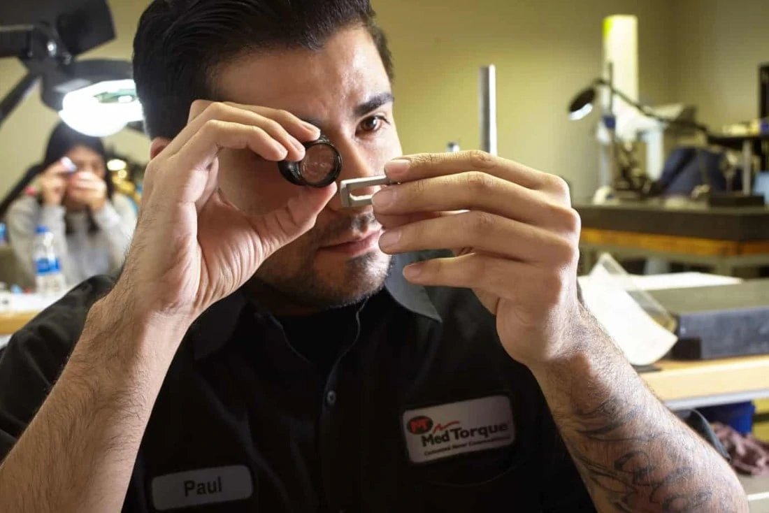 man examining machined part for machining career