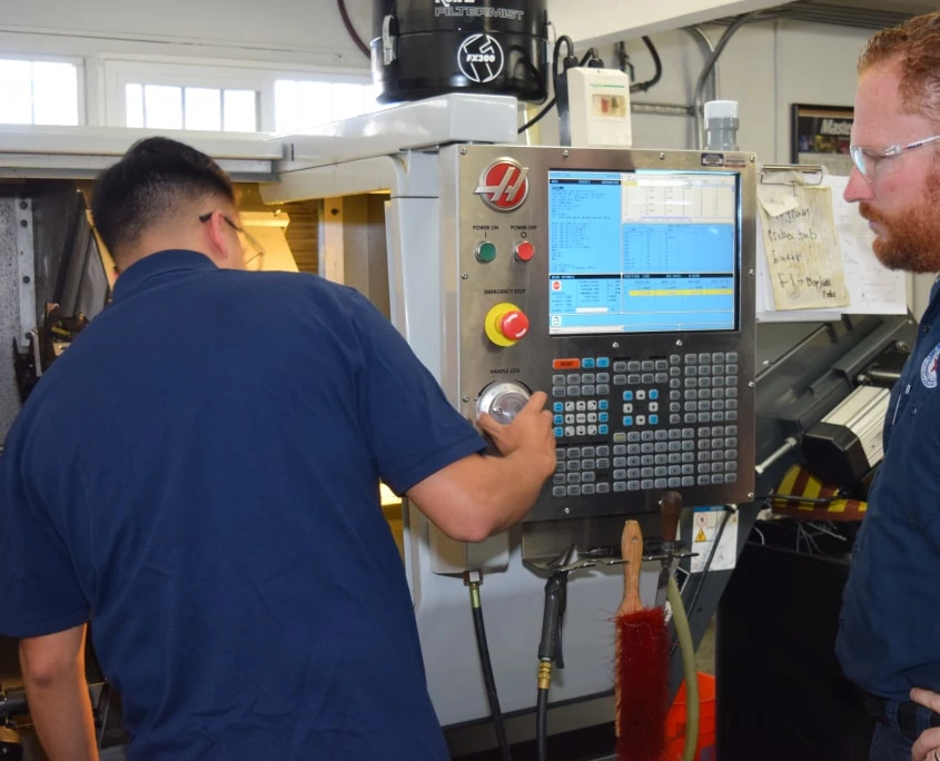men setting up Haas milling machine